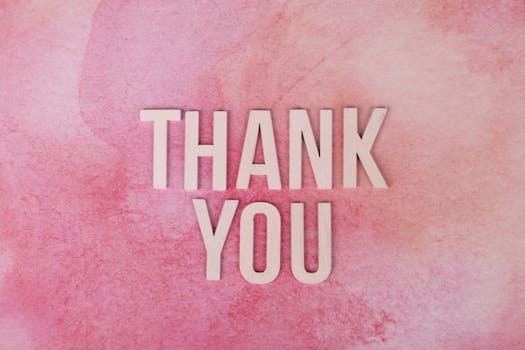 Express gratitude creatively with this 'Thank You' design featuring wooden letters on a pink background.